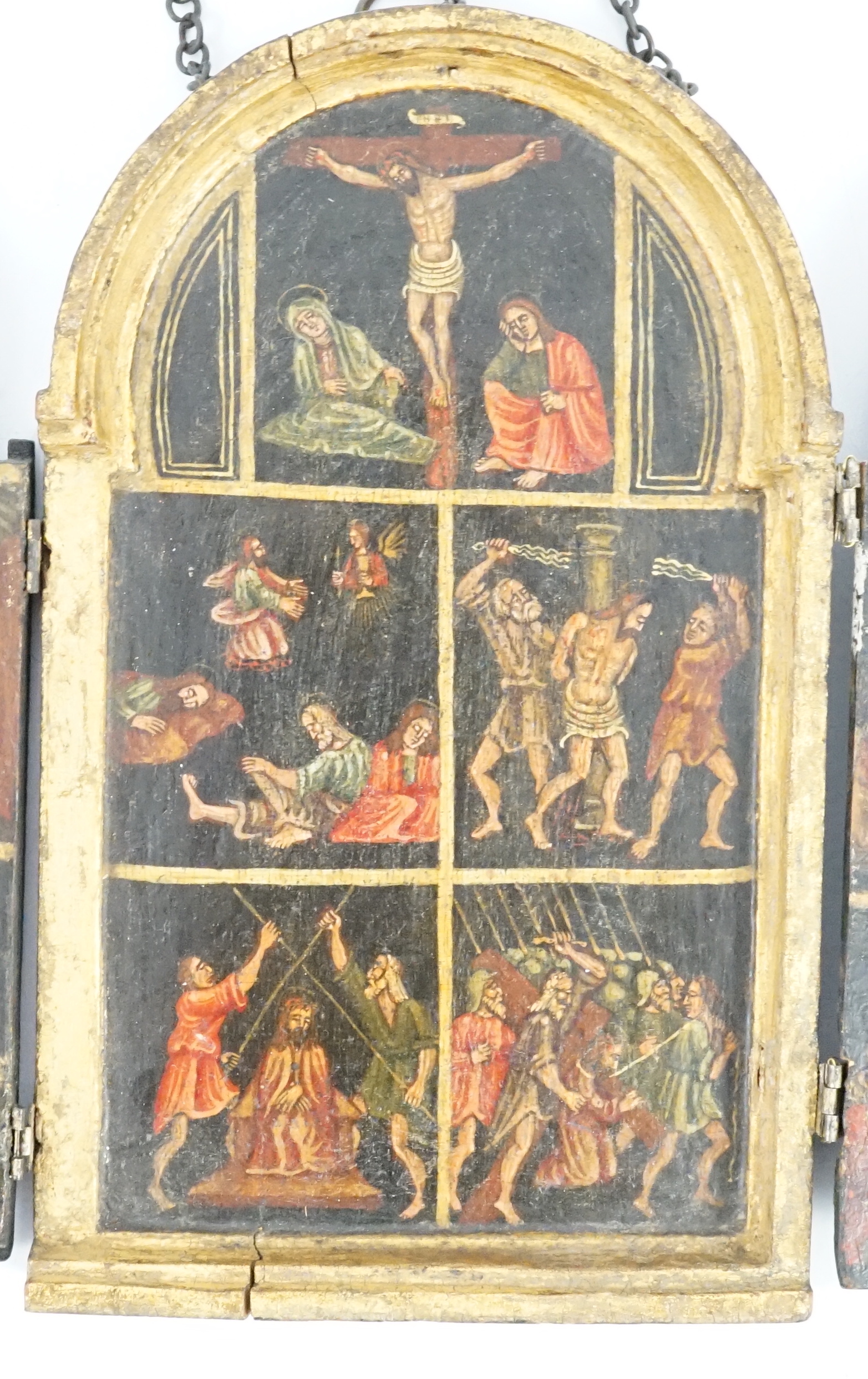A 17th century triptych case, oil on wood, Icon depicting the life of Christ, with a Saint receiving stigmata on one of the two doors, 11.5cm wide, 18.75cm high, when opened out 33.5cm wide
